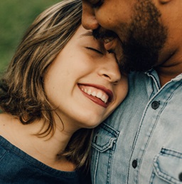 A happy couple holding each other’s hands.